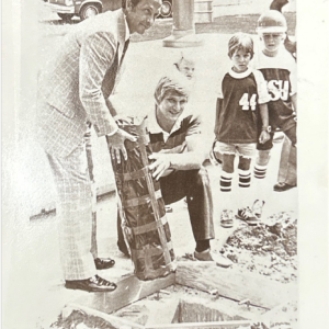 Dr. Kent Wyatt and SGA President Cary Karlson lower the time capsule into place during 1975's celebration of Delta State's 50th anniversary.