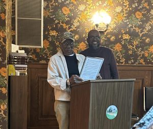 two men, light, podium