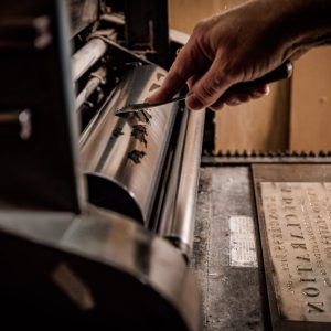 Dunlap broadside inking the press, lettering