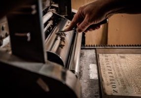Dunlap broadside inking the press, lettering